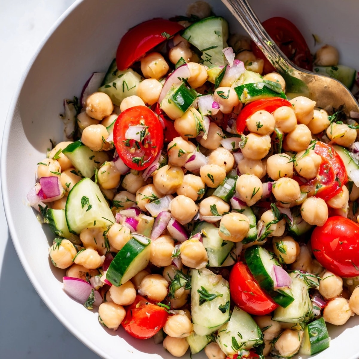 Tangy Lemon Herb Chickpea Salad with juicy tomatoes and fresh dill aroma.