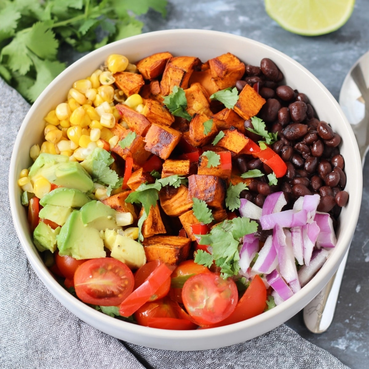 Close-up of a colorful Sweet Potato Black Bean Bowl ready for a nutritious meal.