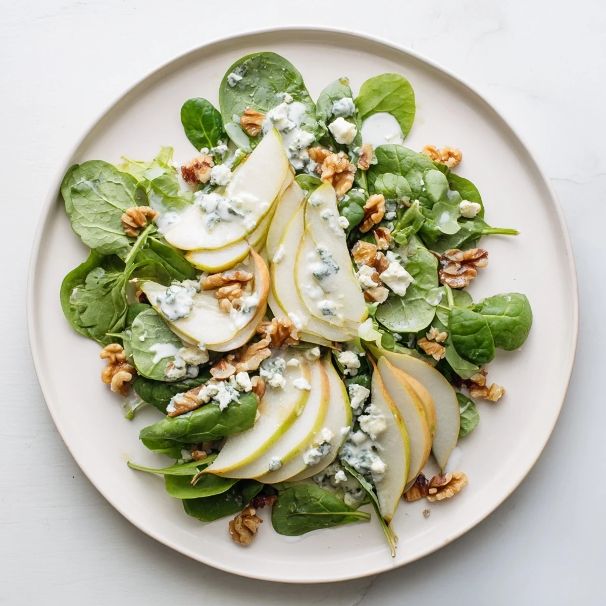 A vibrant photo showcases the prepared Frosted Pear Greens salad, ready to be enjoyed with friends.