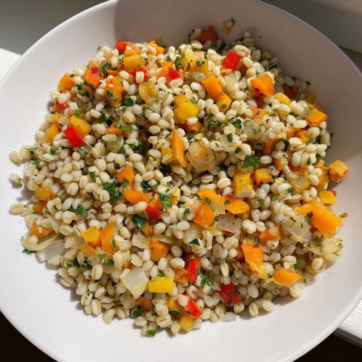 Steaming bowl of roasted savory grain, garnished with fresh parsley and a squeeze of lemon juice.