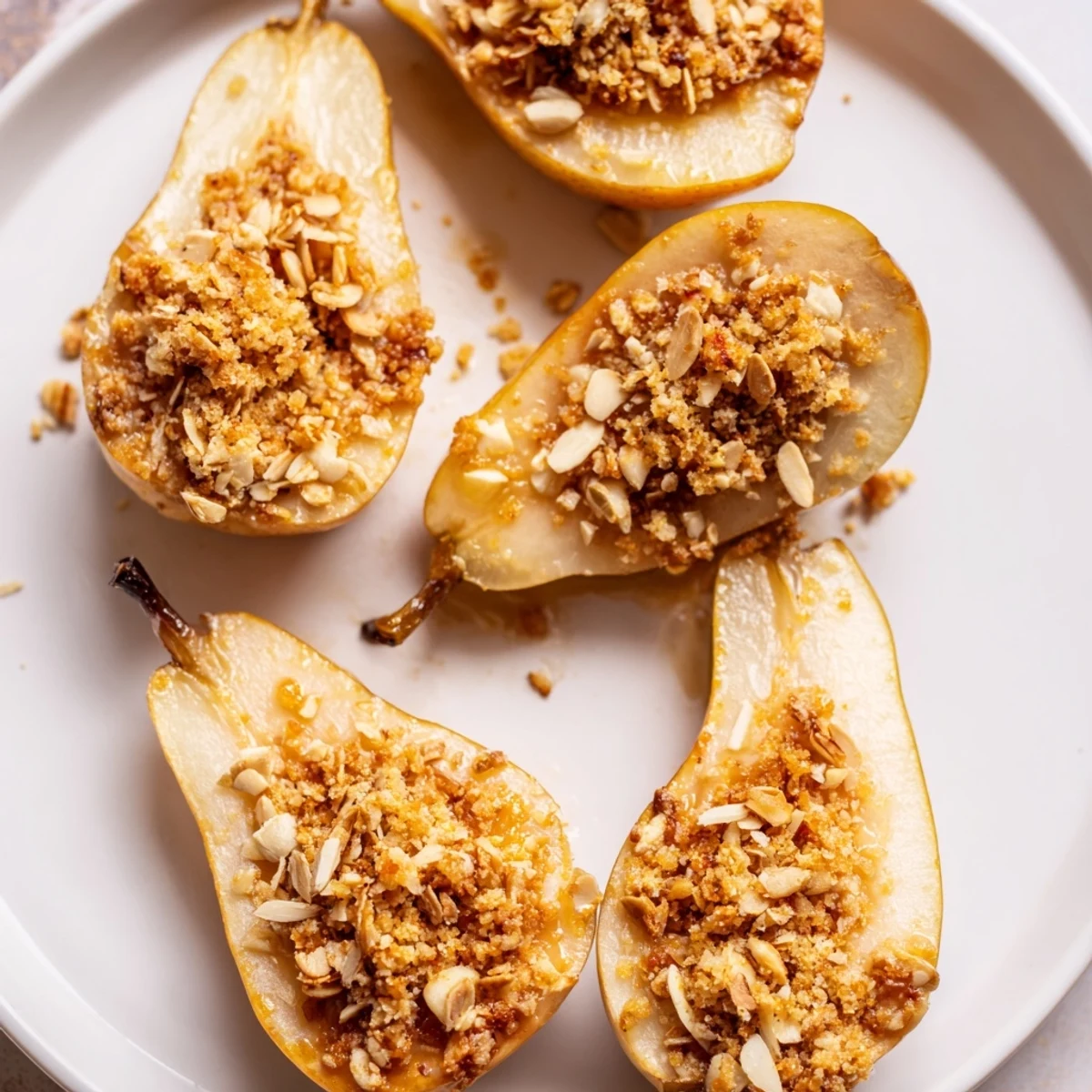 Close-up of baked Toasty Ginger Pears, showing tender pears and a crisp, buttery oat topping.
