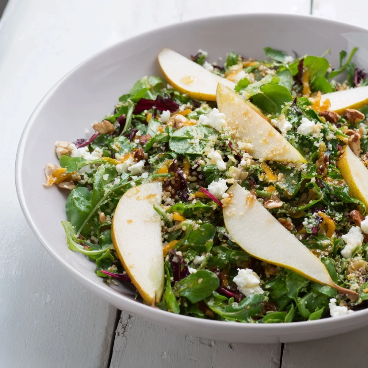 Fresh Pear & Greens Salad, a vibrant mix of pears, crunchy nuts, and a light balsamic vinaigrette.