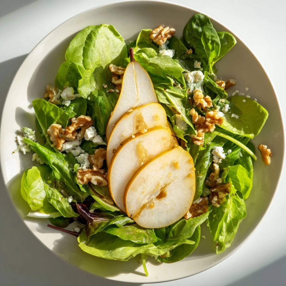 Beautiful plate of Bright Pear Greens; fresh pear slices atop vibrant, sauteed greens.