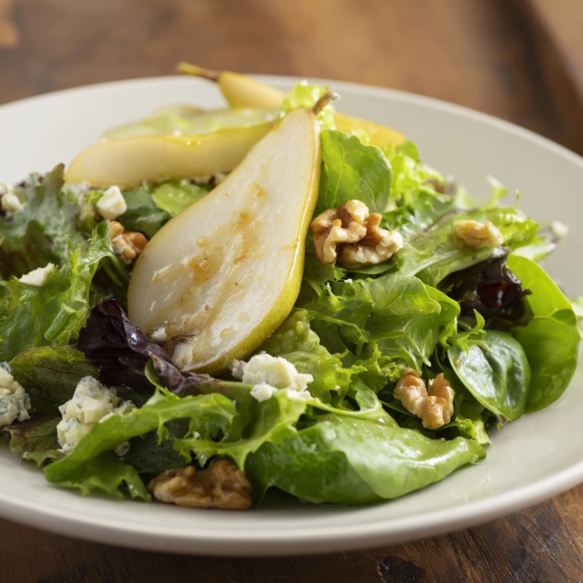 Savory Bright Pear Greens: A warm bowl of leafy greens drizzled with a light vinaigrette.