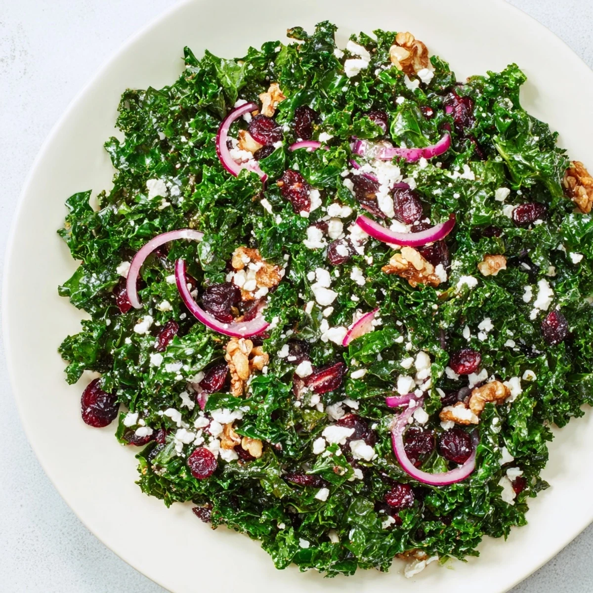 This delicious Cranberry Kale Salad shows tender kale, toasted nuts, and a flavorful homemade dressing.