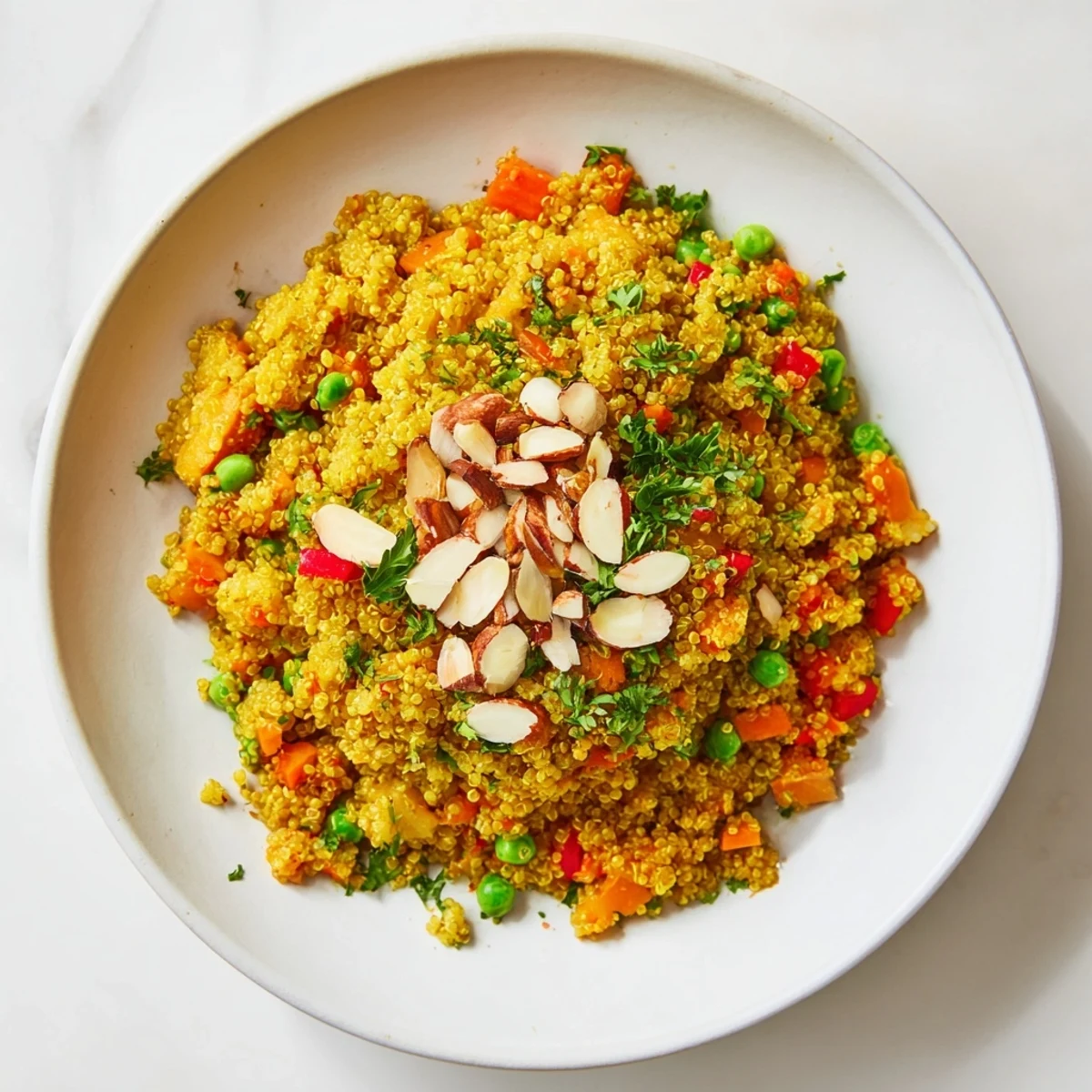 A steaming bowl of Golden Savory Grain, with visible carrots, peppers, and fluffy quinoa grains.