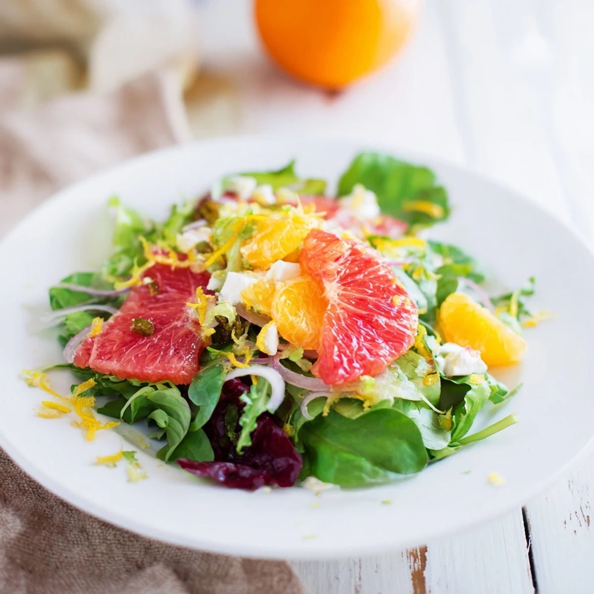 Enjoy the zesty Citrus Greens, a flavorful combination of greens, citrus fruits, and crunchy toppings.