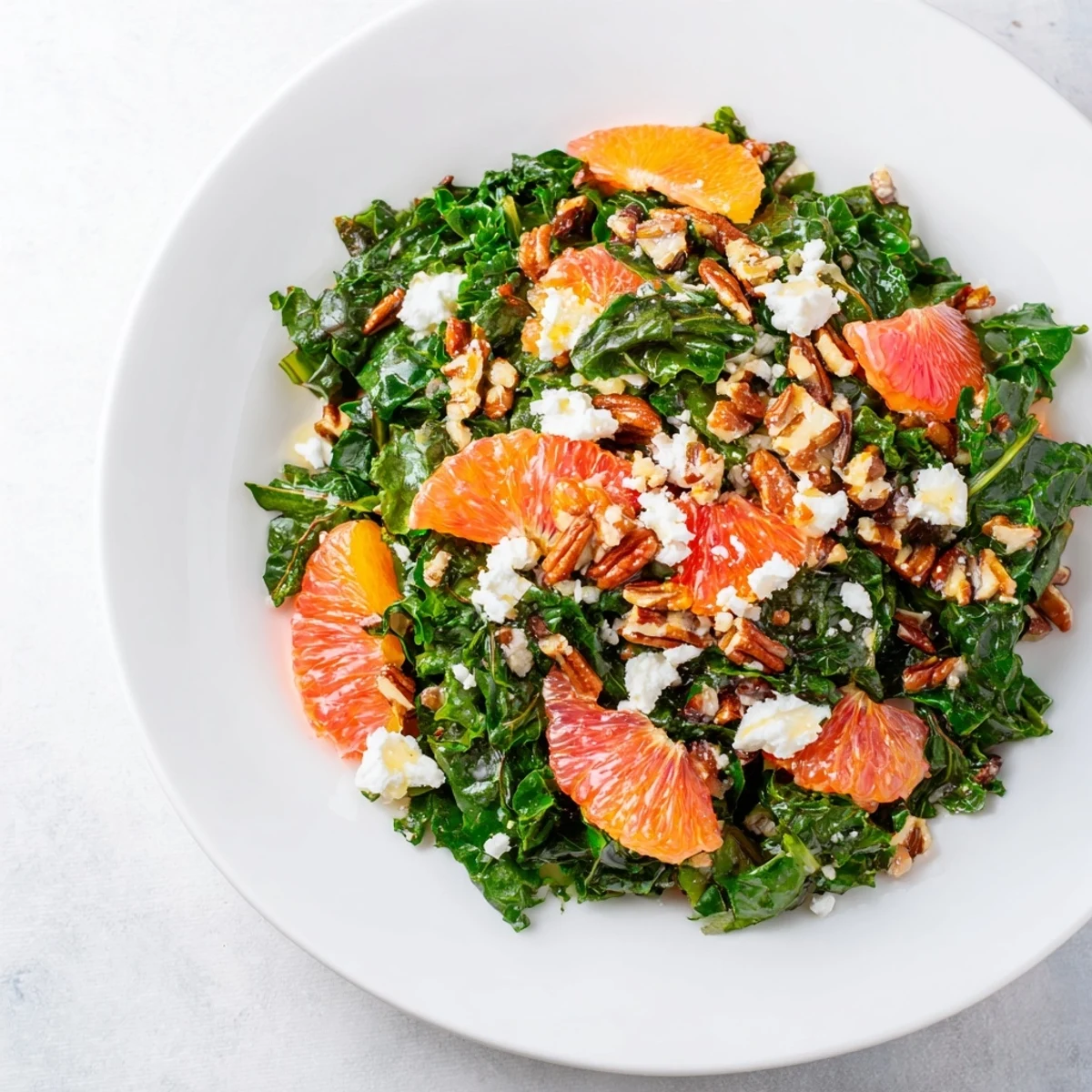 A fresh, flavorful bowl of Cozy Citrus Greens, a winter salad with a citrus vinaigrette dressing.