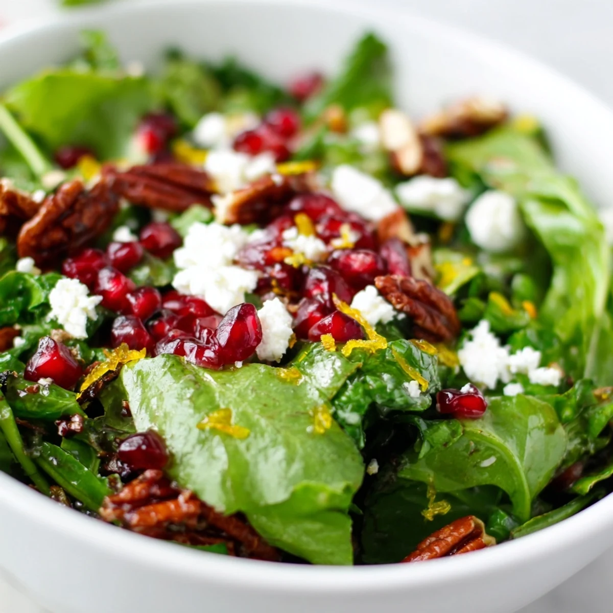 Fresh Frosted Winter Greens salad with crisp kale, spinach, and a bright citrus vinaigrette topped with candied nuts.