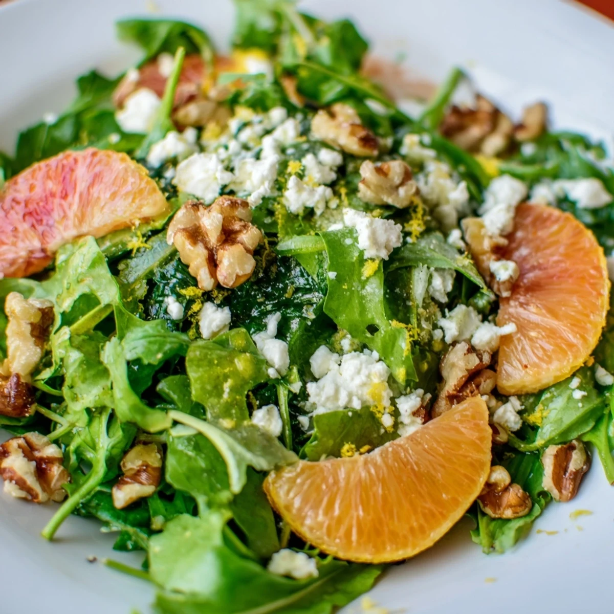 Zesty Savory Citrus Greens salad features mixed greens, lemon zest, and feta cheese, drizzled with a homemade citrus vinaigrette dressing.