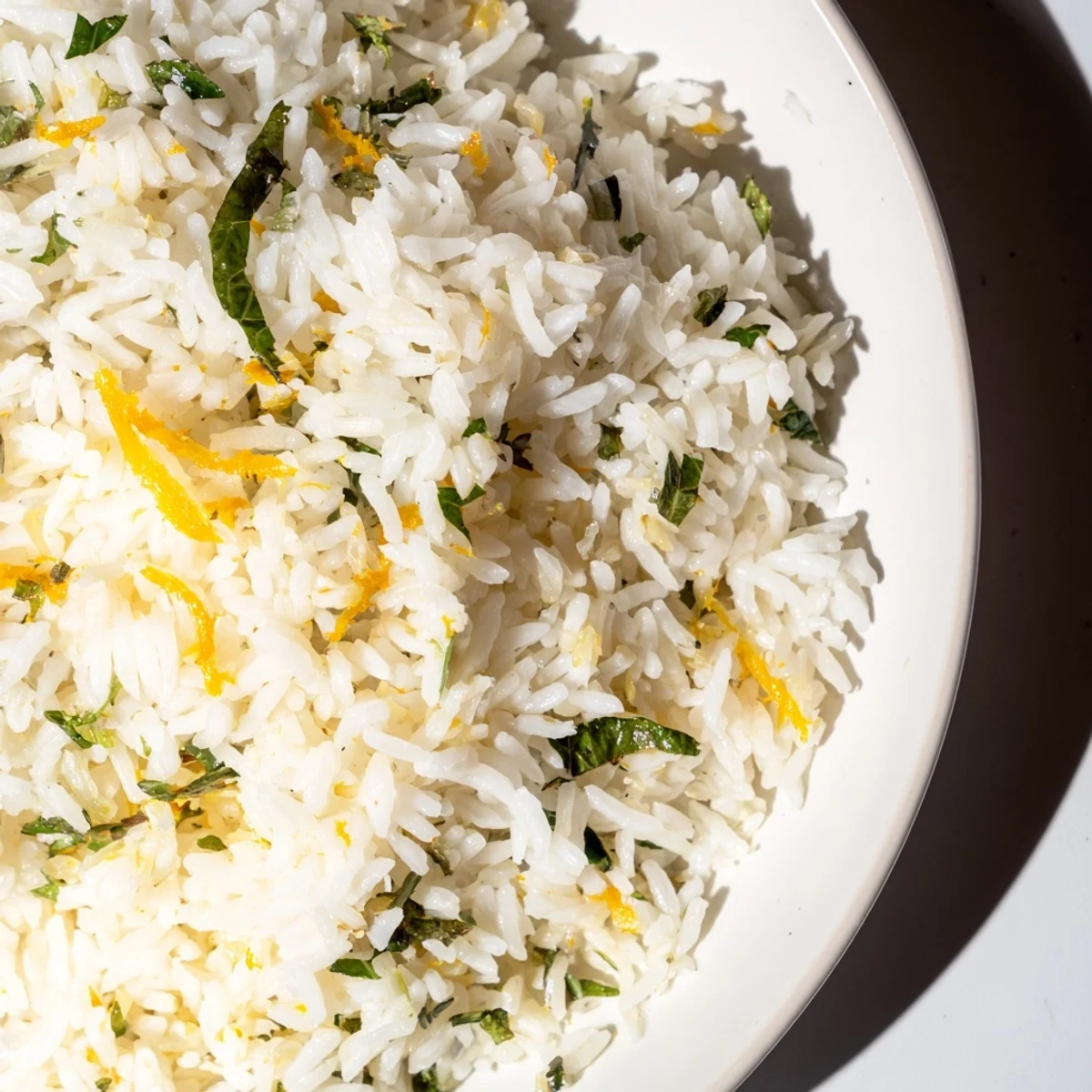 Citrus Warm Rice steaming in a skillet with olive oil and shallots, ready for a light vegetarian meal.