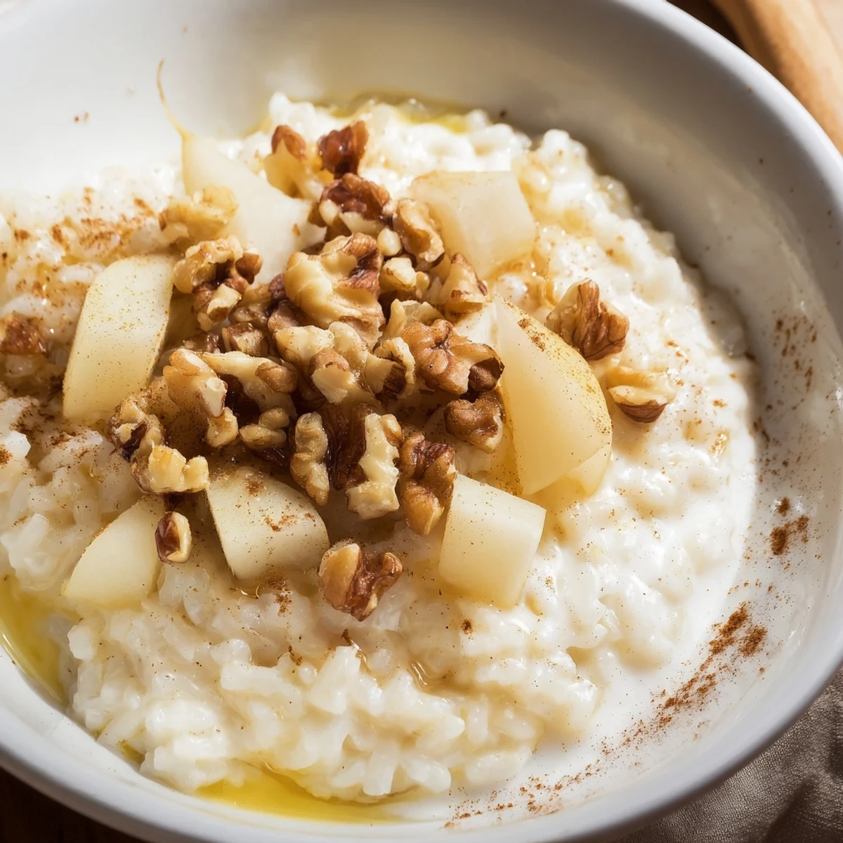 Cozy comfort food photo of Pear Warm Rice served in a rustic ceramic bowl.