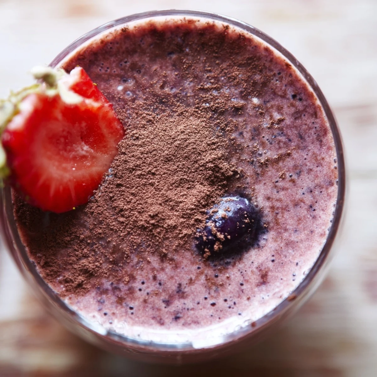 Cranberry Cocoa Berry smoothie in a chilled glass, garnished with fresh berries and cocoa dusting, perfect for a healthy breakfast.