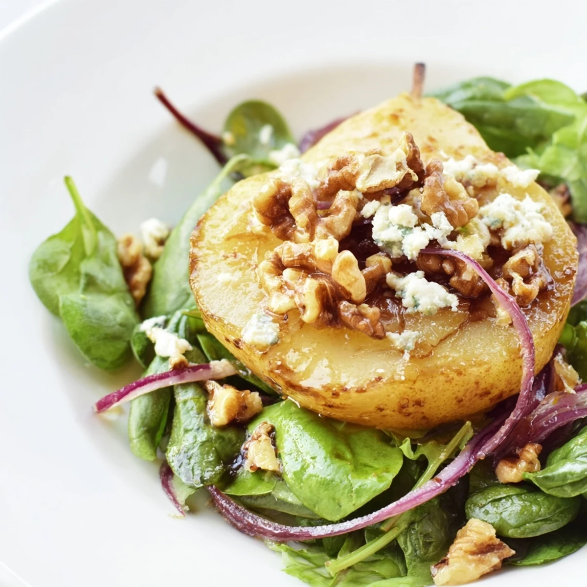 A close-up of caramelized pears sizzling in a skillet with butter, ready to top the vibrant salad greens.
