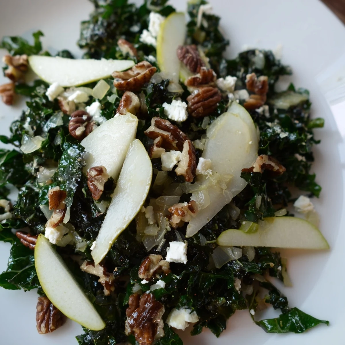Freshly massaged kale and sliced ripe pears tossed in a zesty lemon-honey vinaigrette for a crisp, nutritious salad. Perfect for a light lunch topped with toasted walnuts and crumbled goat cheese.