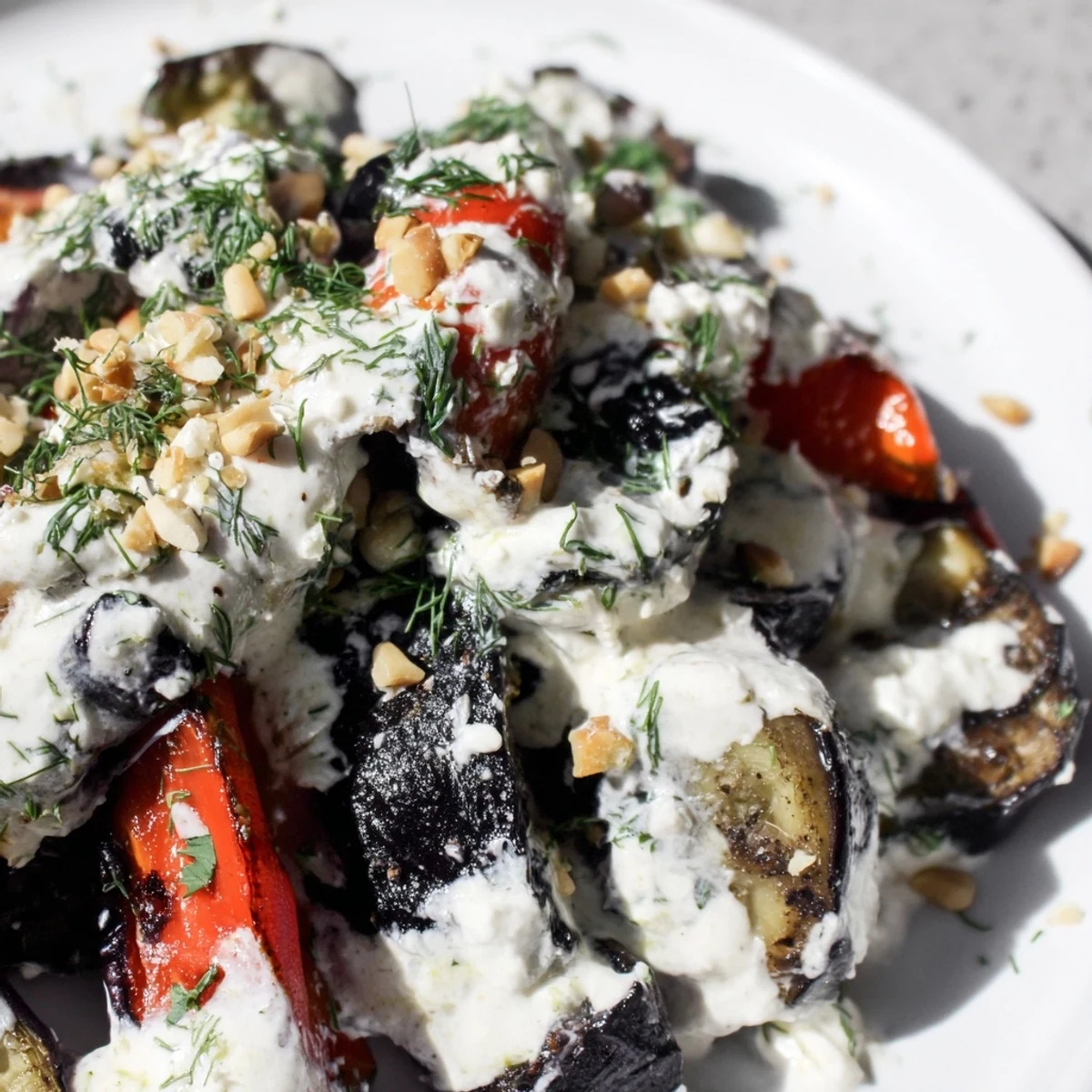 Smoky grilled vegetable medley with snowy feta dressing and fresh parsley garnish.