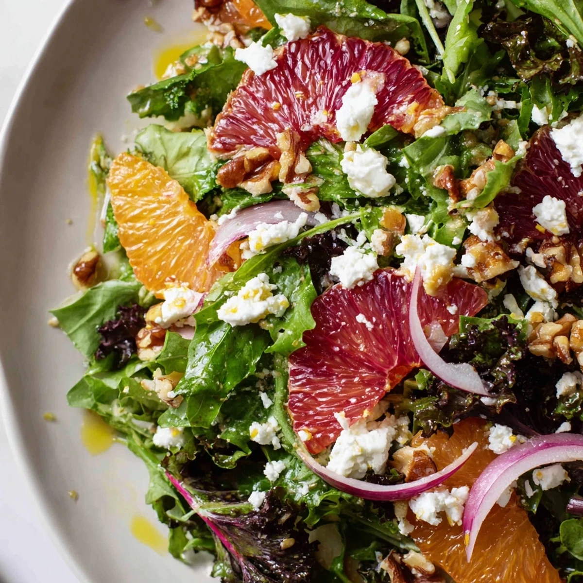 Winter Citrus Greens salad features segmented oranges and grapefruit over crisp mixed greens topped with crumbled goat cheese.