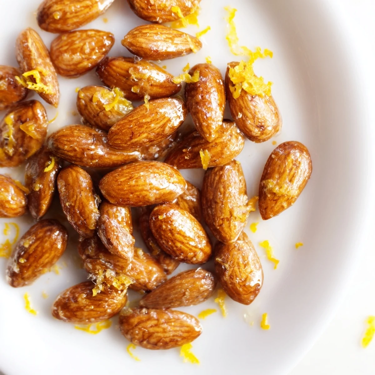 Golden Citrus Toasted Almond pieces cooling on a baking sheet, releasing a sweet and zesty aroma.
