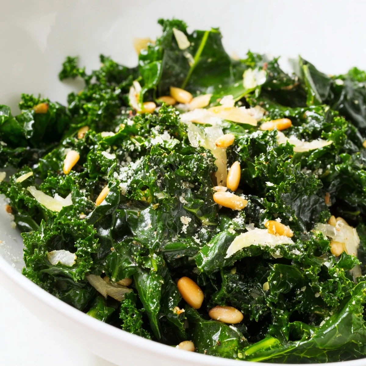 Freshly sautéed Cozy Kale with garlic and shallots in a skillet, glistening with olive oil and a bright squeeze of lemon juice.  