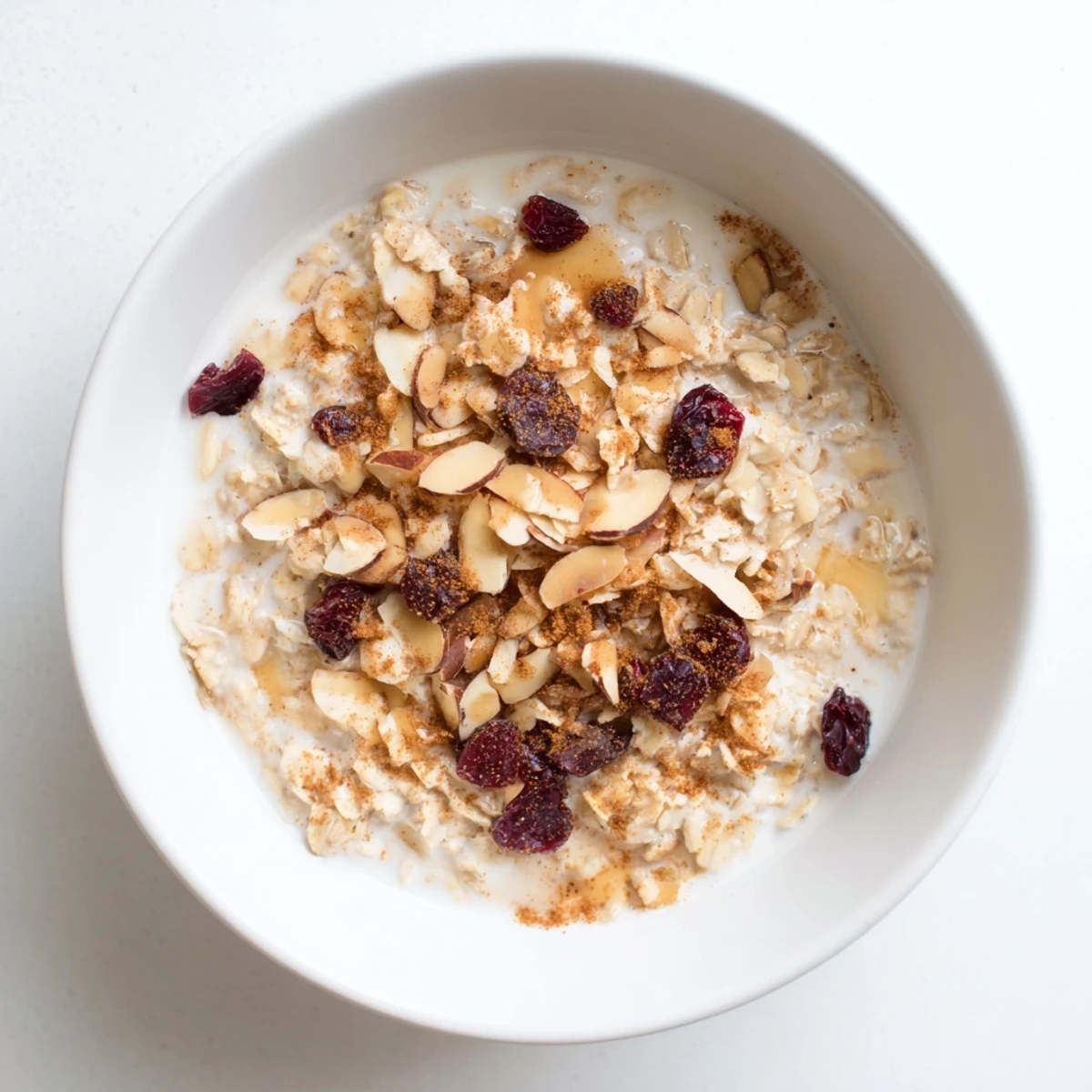 A comforting bowl of Winter Chai Oat garnished with warm spices and served alongside a steaming mug of masala chai.  