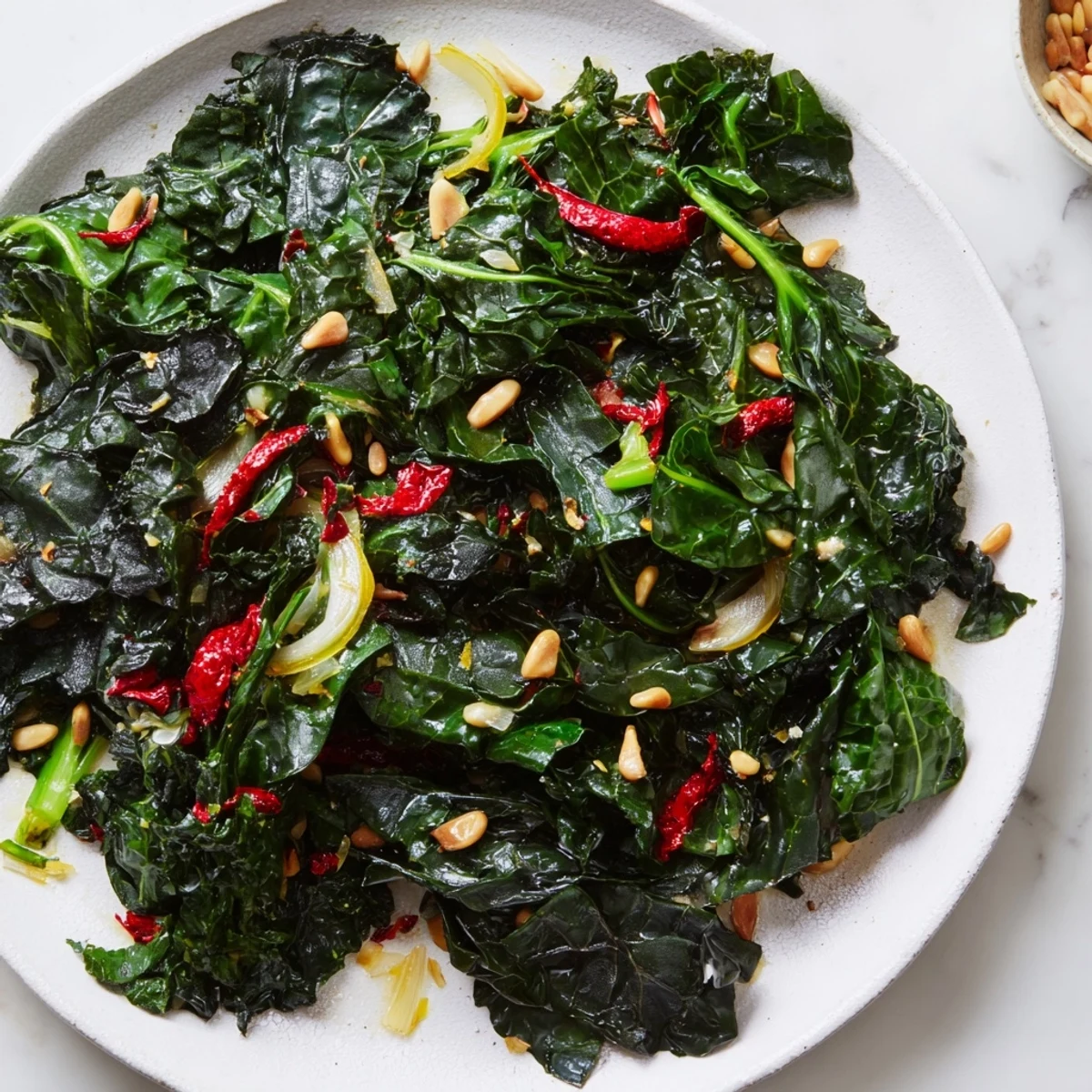 Freshly wilted Bright Winter Greens with garlic and lemon, served warm as a vibrant vegan side dish.