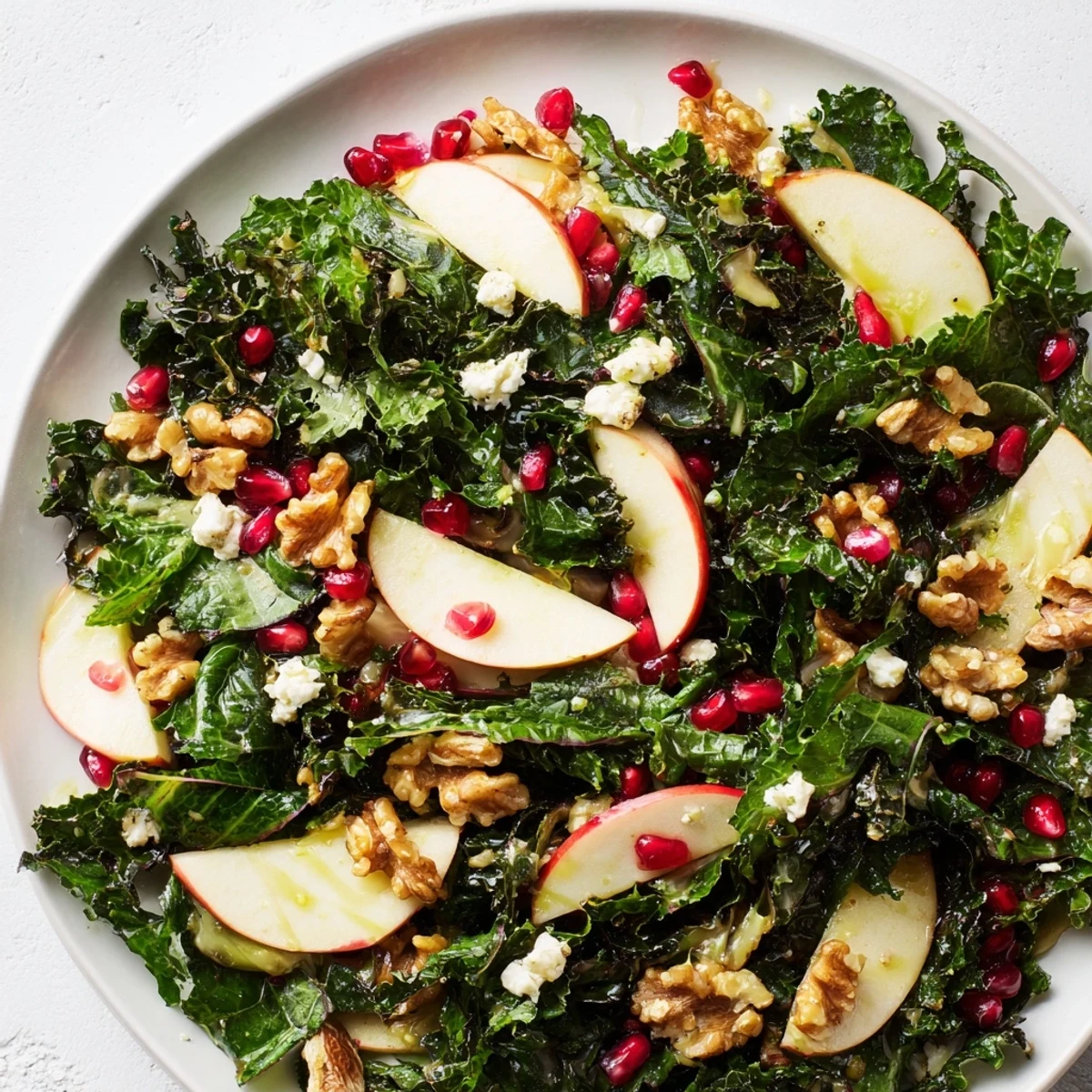 Winter Greens Salad arranged in a white bowl with crisp leaves, sweet apples, tangy vinaigrette, and optional feta, ready for a healthy lunch.