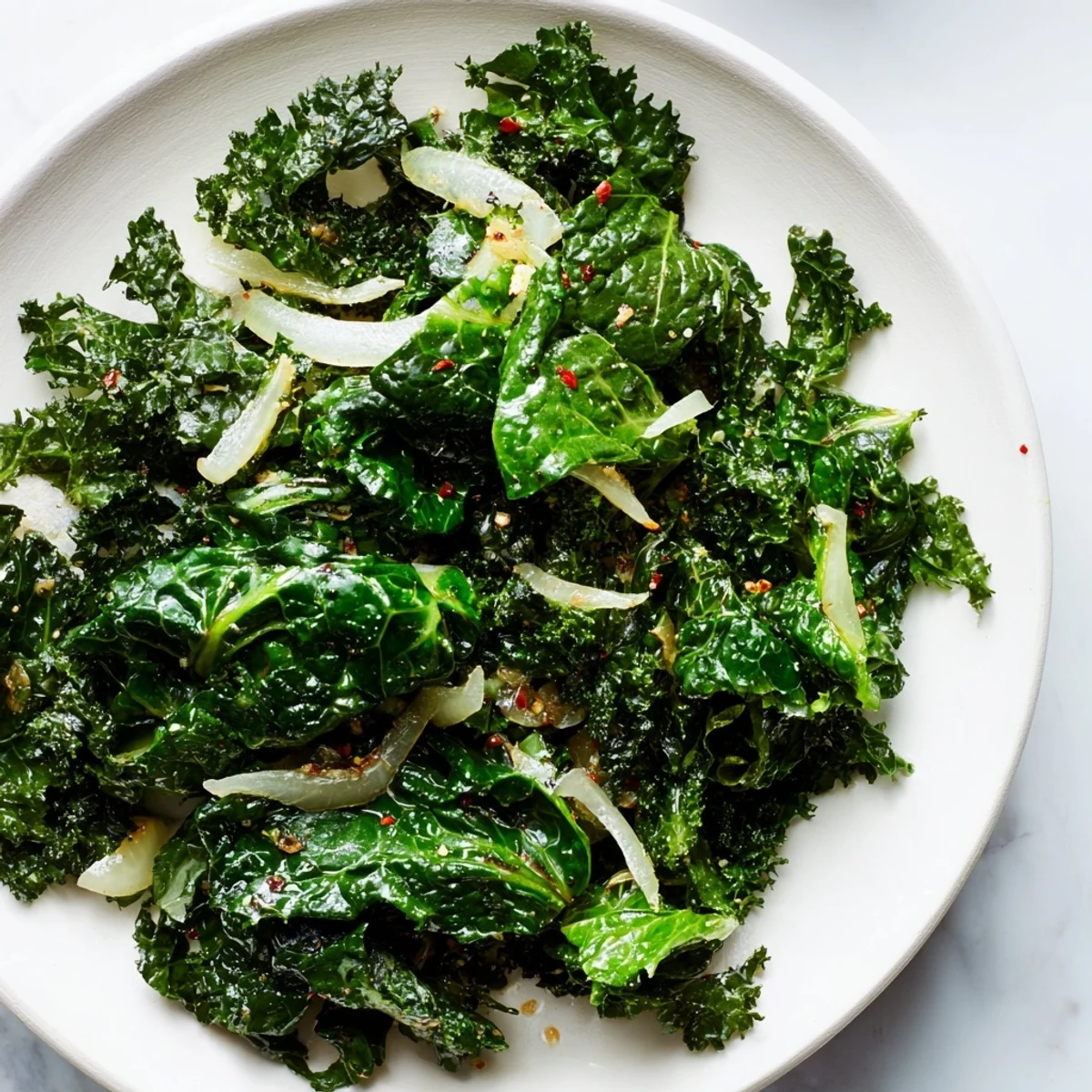 Fresh ginger kale sizzling in a skillet, with aromatic garlic and a bright squeeze of lemon for flavor.