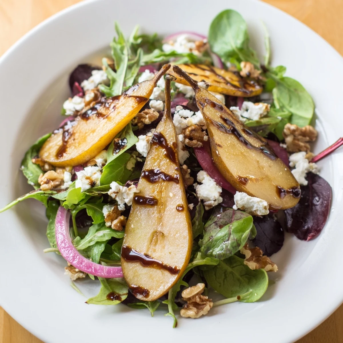 Roasted pears and toasted walnuts top the Hearth Pear Greens salad with tangy goat cheese.