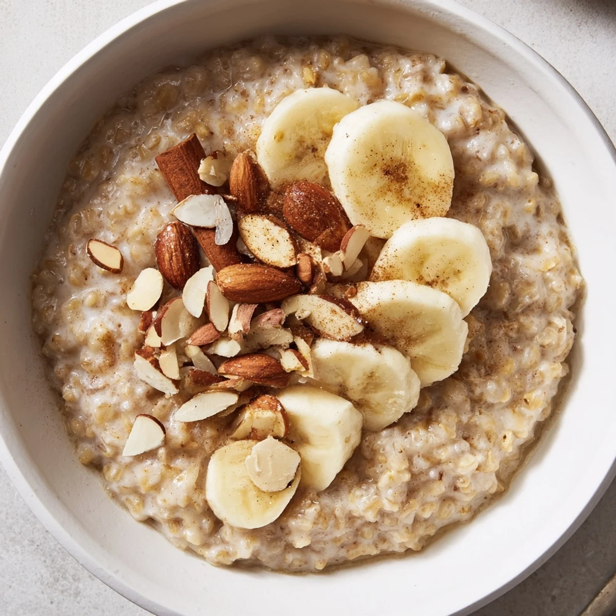 A comforting spoonful of creamy ginger barley porridge with cinnamon, perfect for a nourishing light supper.