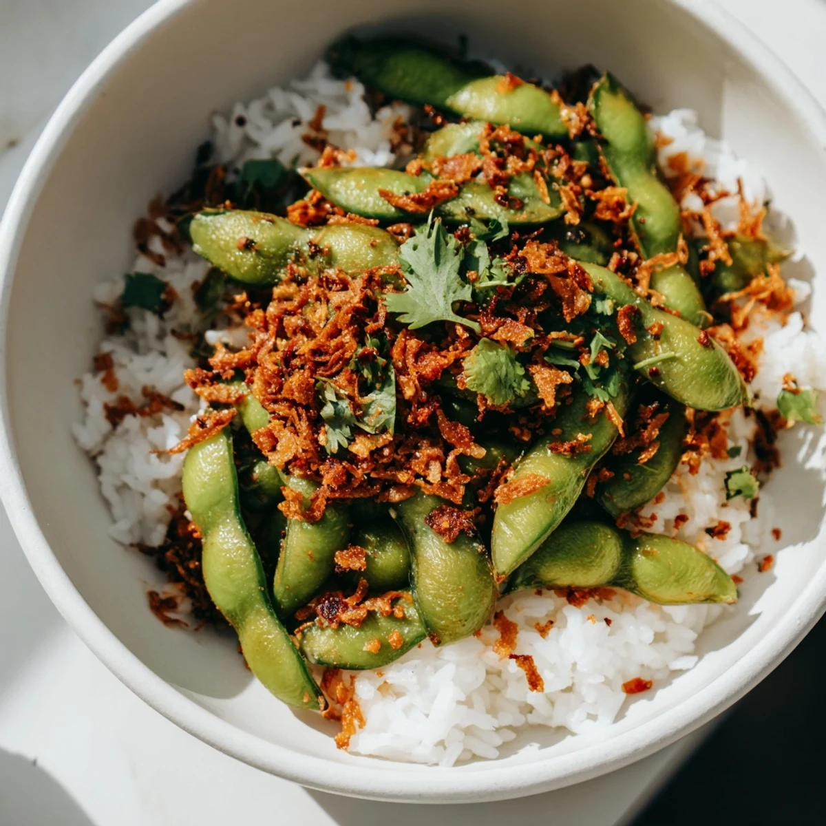 A colorful bowl of Spicy Chili Oil Edamame Veggie Bowl with Crispy Garlic ready to serve.