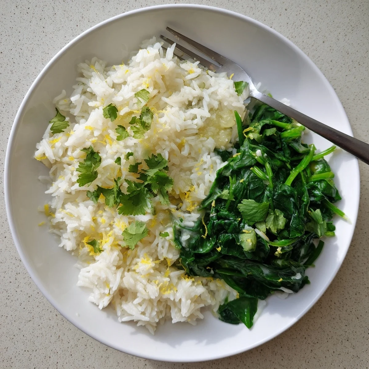 Fluffy jasmine rice simmered in coconut milk, paired with garlicky sautéed spinach and bright lime.  