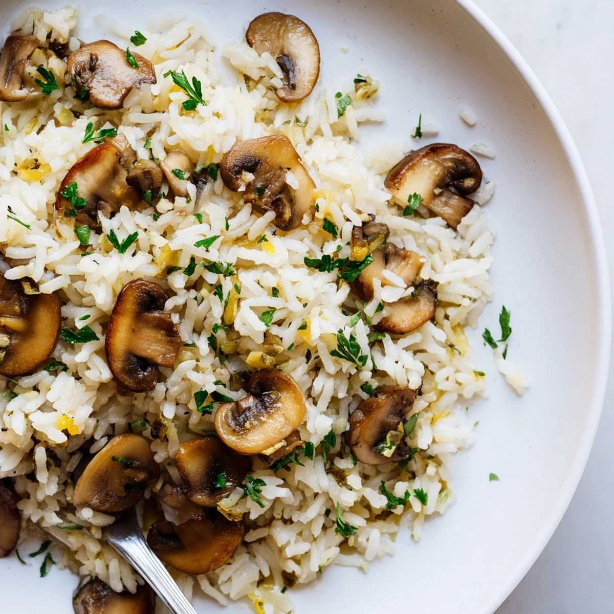 Fluffy white rice dish with sautéed mushrooms and aromatic thyme sprigs on top