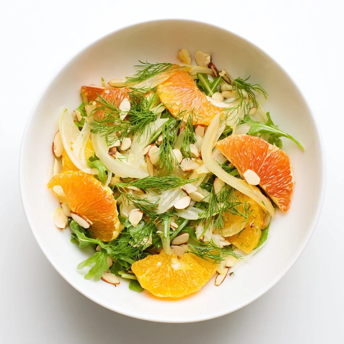Fresh Mediterranean salad featuring crisp fennel, citrus segments, and peppery arugula leaves