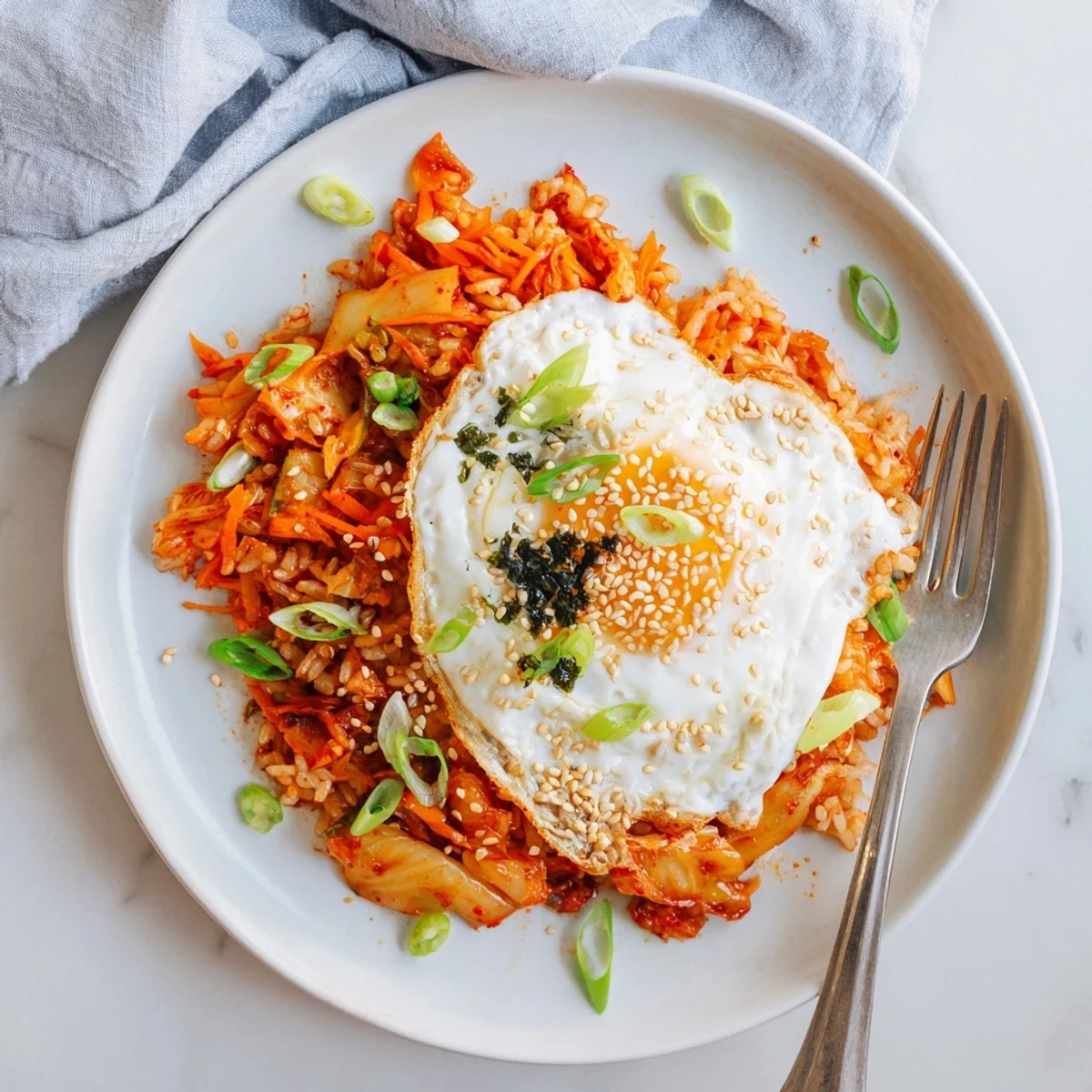 Vibrant spicy kimchi sesame rice bowl garnished with fresh scallions and sesame seeds