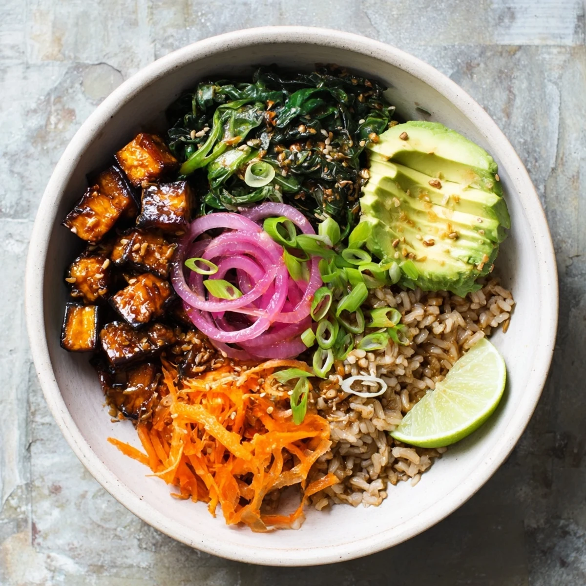 Vegan bowl featuring tender maple miso roasted eggplant alongside fresh avocado and vibrant vegetables