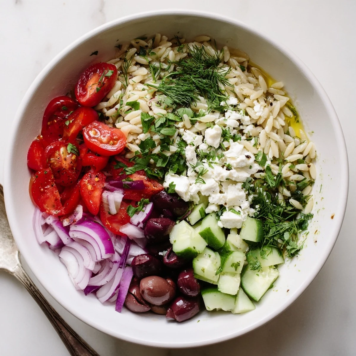 Wholesome Mediterranean roasted tomato orzo grain bowl featuring juicy tomatoes and crumbled feta cheese