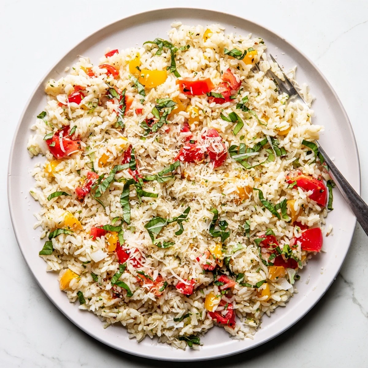 Vibrant vegetarian fried rice featuring aromatic garlic basil tomatoes and cheesy Parmesan finish