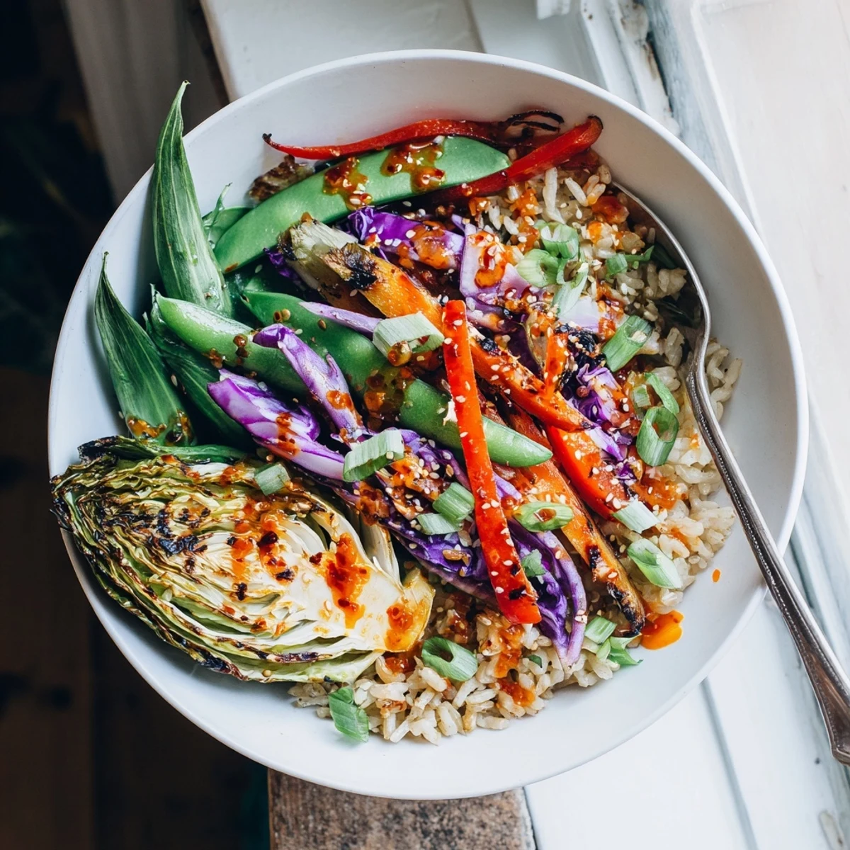 Hearty veggie bowl with caramelized roasted cabbage drizzled in homemade spicy chili oil dressing