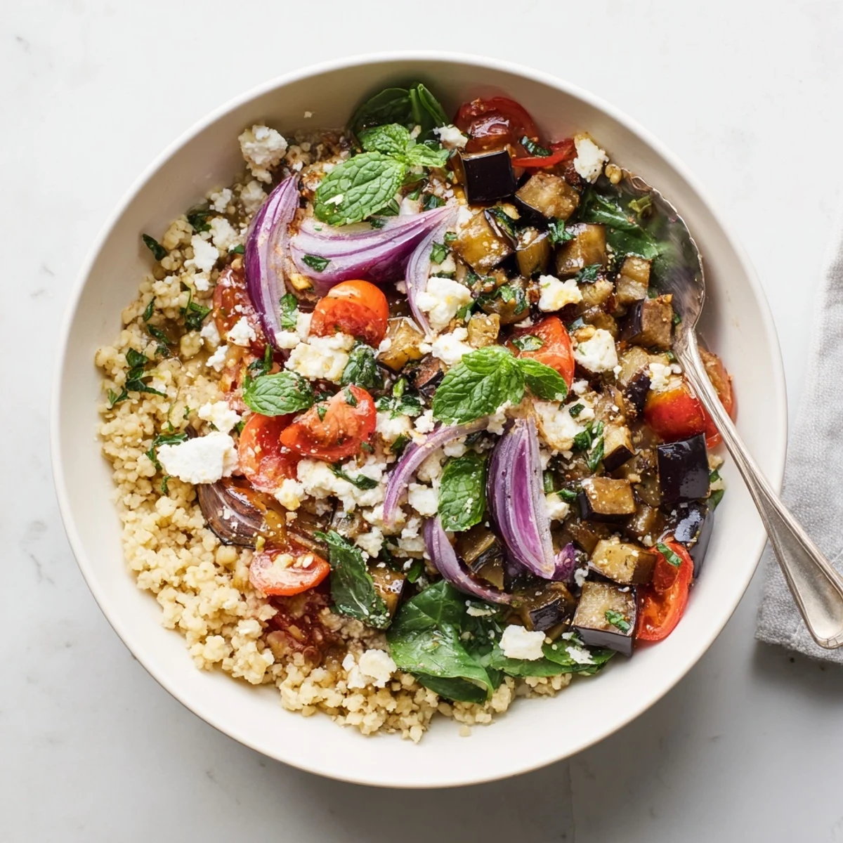 Vibrant vegetarian grain bowl featuring smoky roasted eggplant and fluffy bulgur wheat