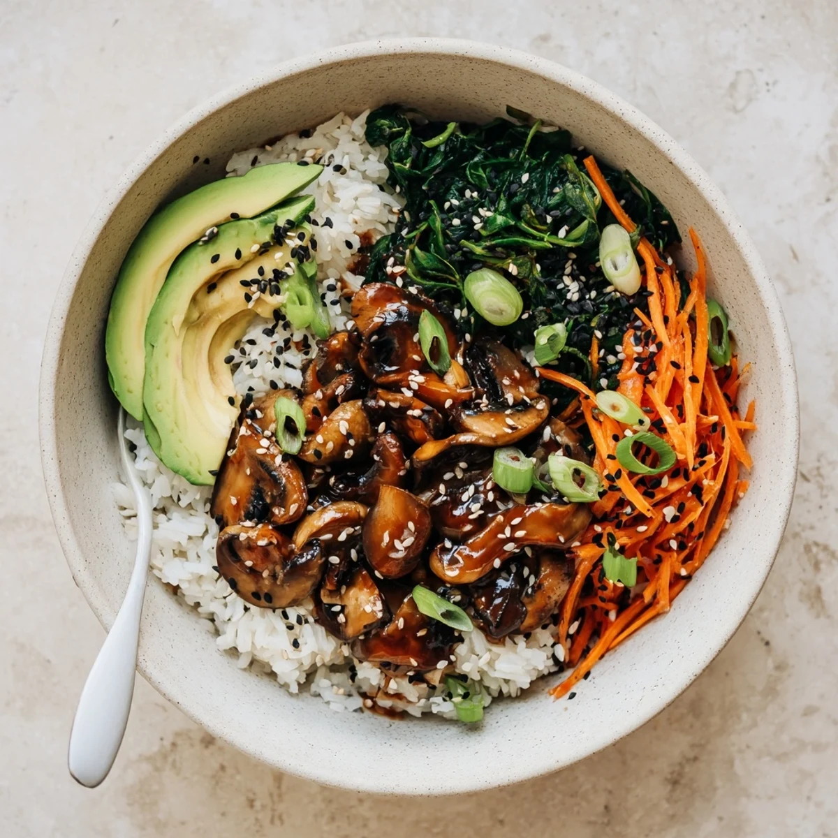 Glossy teriyaki mushrooms atop fluffy rice with sesame greens and fresh spring onions