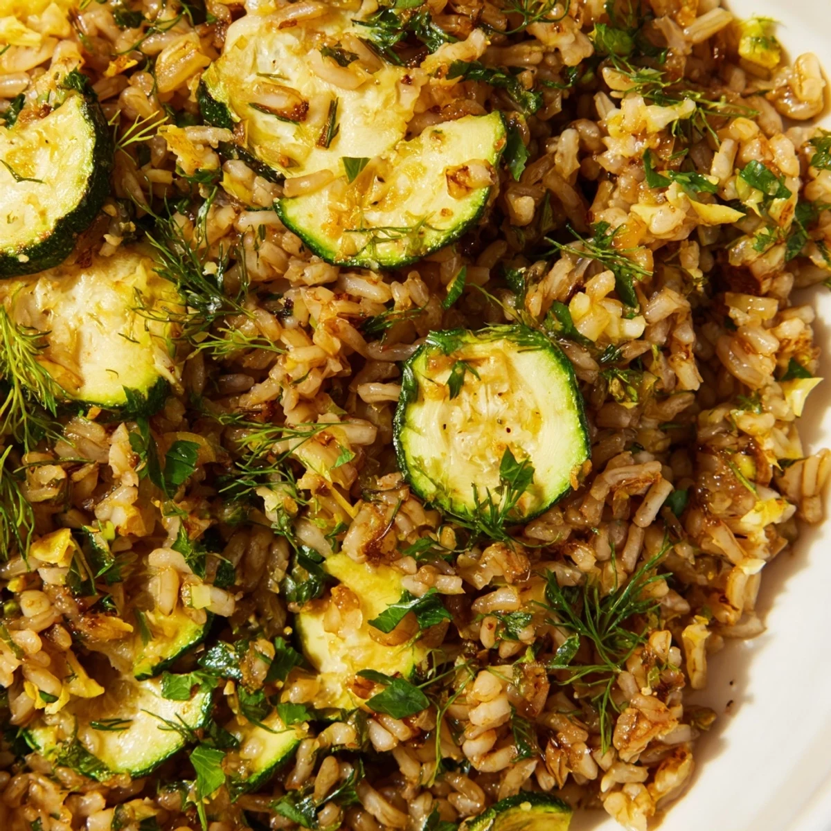 Mediterranean-inspired brown rice dish featuring tender roasted zucchini and aromatic herbs