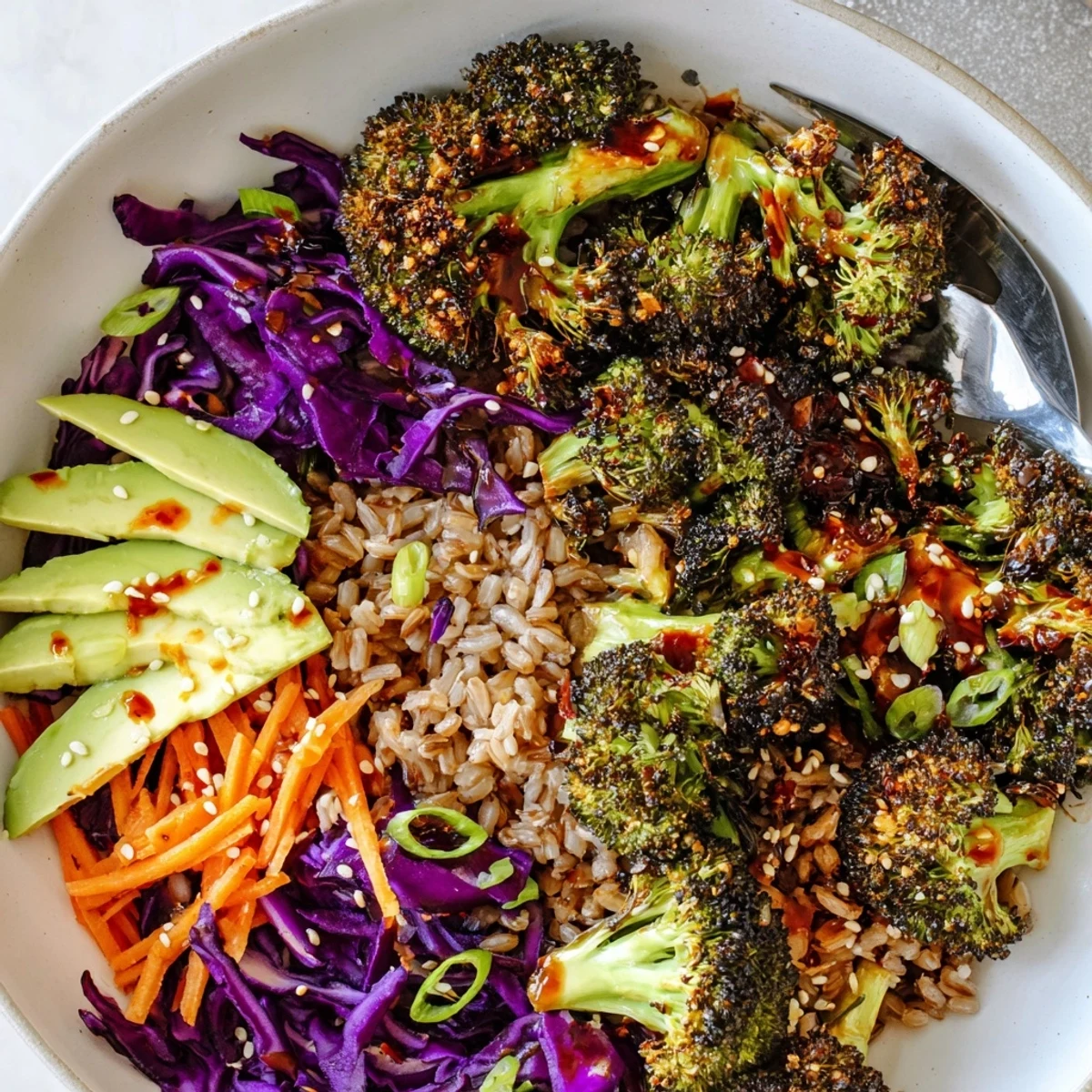 Spicy Chili Crisp Roasted Broccoli Veggie Bowl with Sesame drizzle in a rustic ceramic bowl
