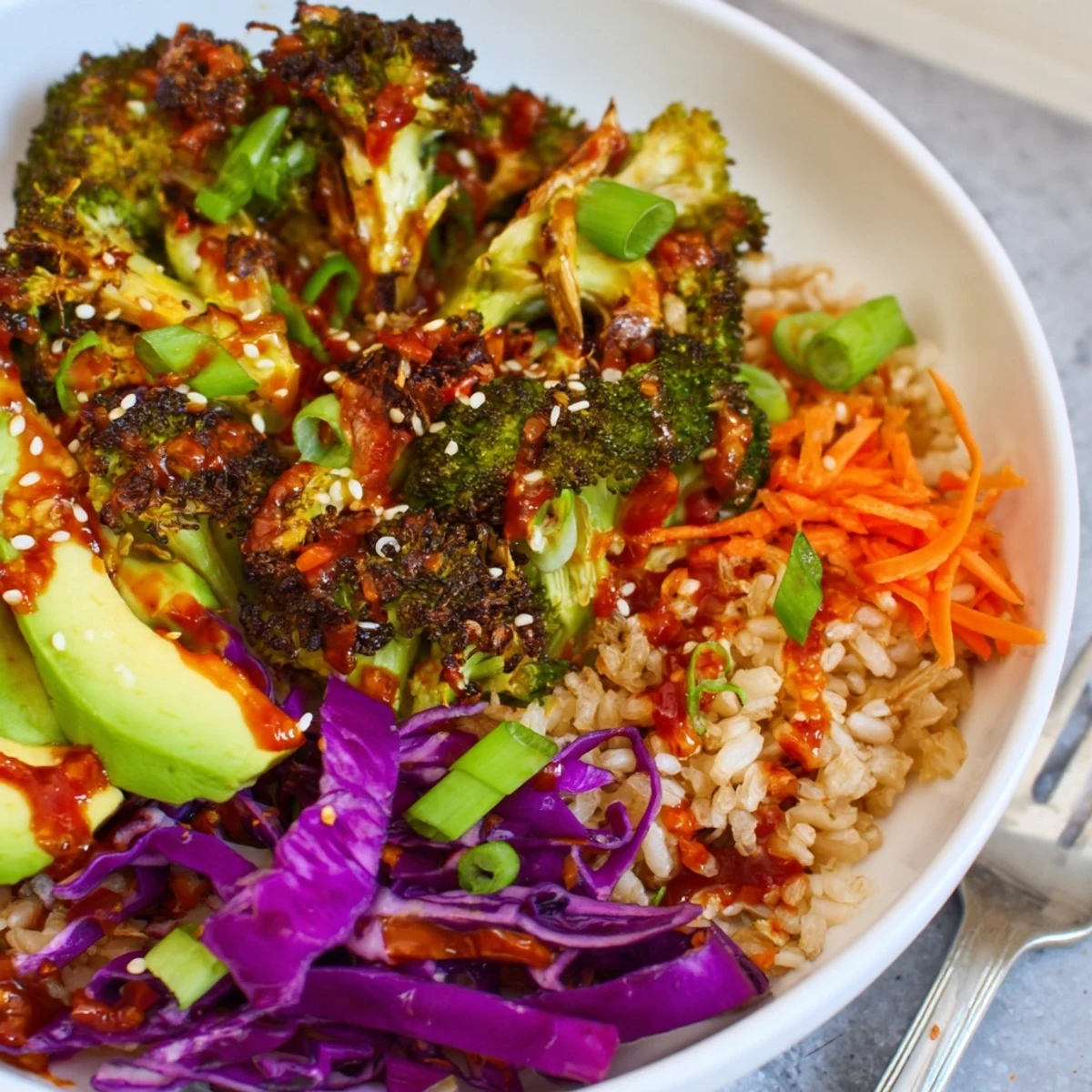 Crispy charred broccoli and colorful fresh vegetables topped with spicy chili crisp sesame dressing