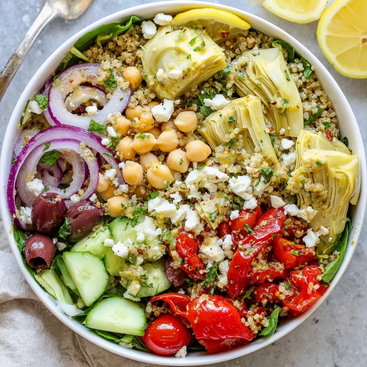Mediterranean Artichoke Quinoa Grain Bowl with Lemon Herbs, bright citrus-tossed vegetables.