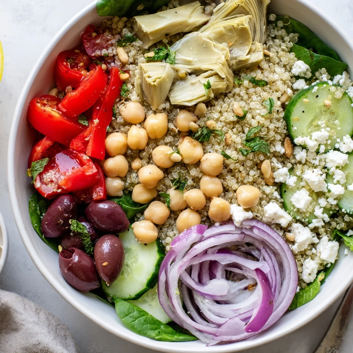 Piled high Mediterranean Artichoke Quinoa Grain Bowl with Lemon Herbs, warm and fragrant.
