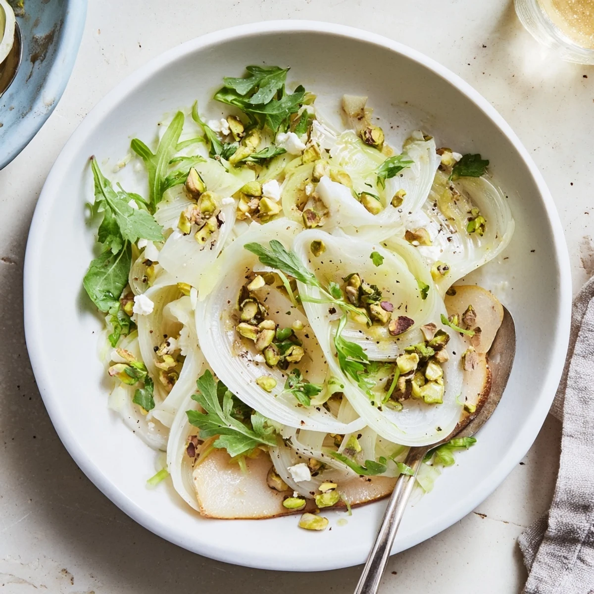 Shaved Fennel Pear Salad Bowl with Pistachio Vinaigrette, crisp slices, juicy pears, lemon zest