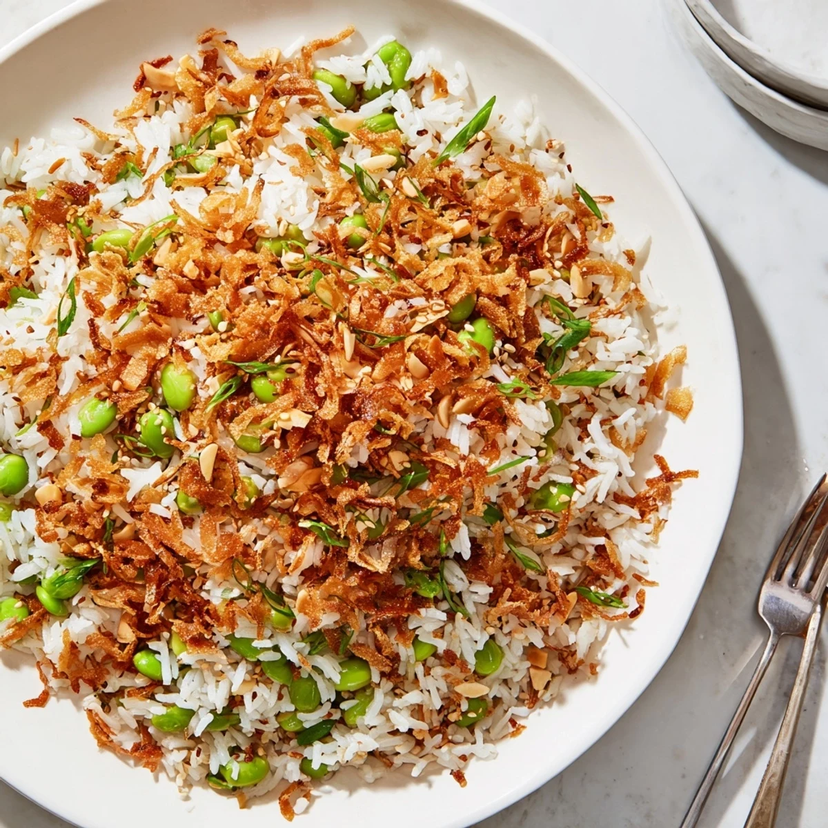 Bowl of Garlic Scallion Edamame Rice Dish with Crispy Onions and scallion greens