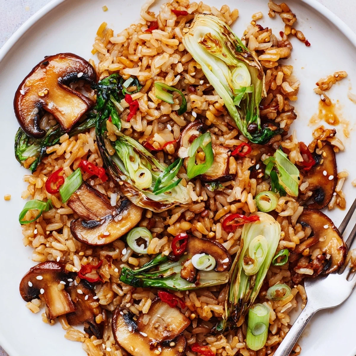 Chili Garlic Mushroom Rice with Bok Choy steaming in skillet, garlicky aroma