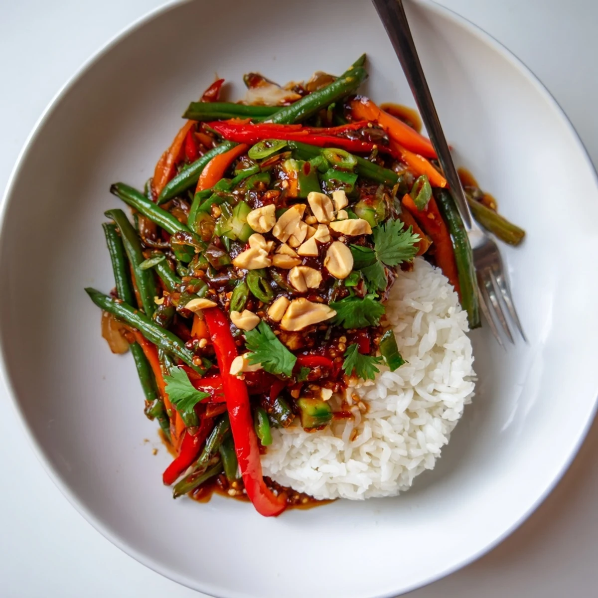Spicy Chili Crisp Green Bean Veggie Bowl with Garlic piled over steaming rice  