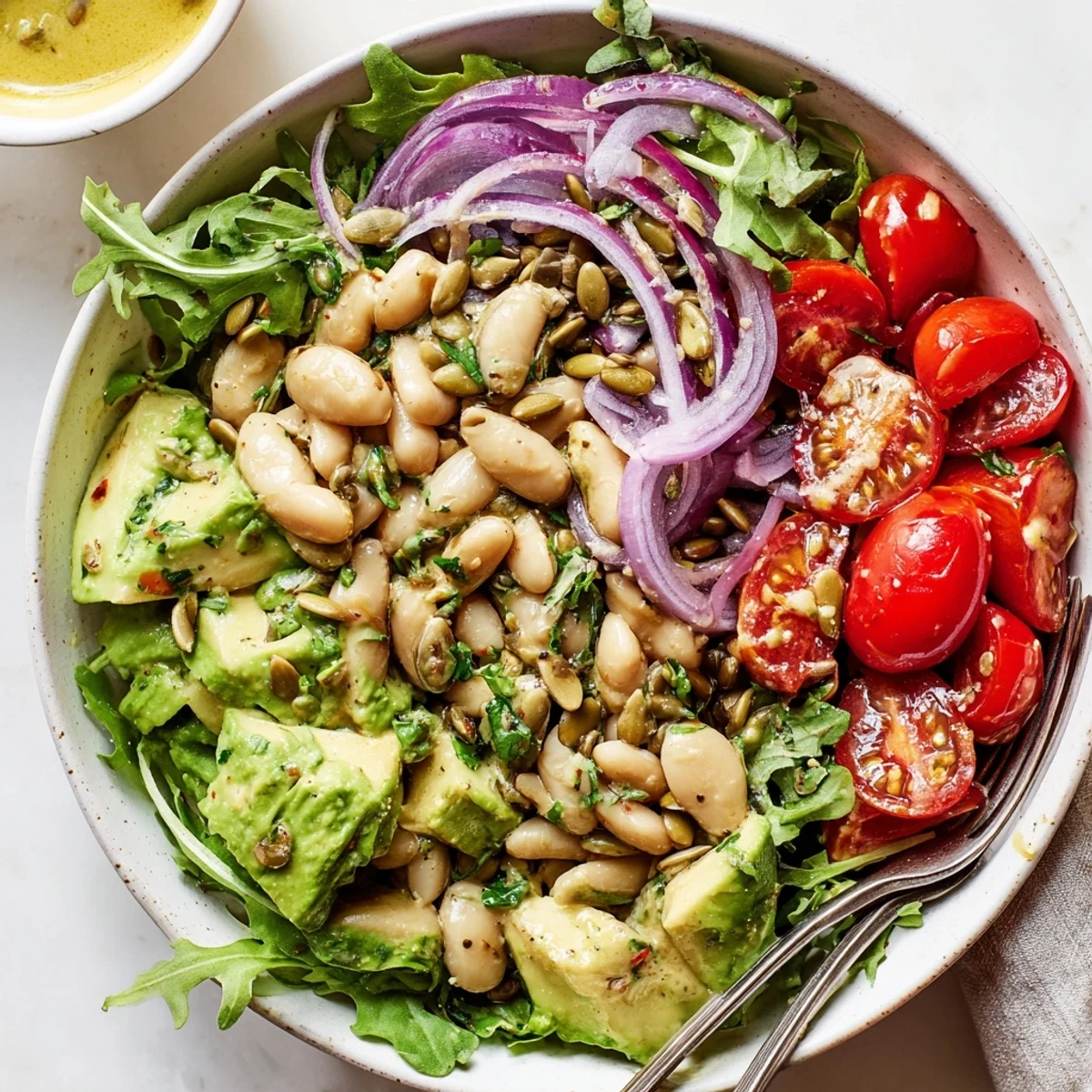 Creamy Avocado Arugula White Bean Salad Bowl with Seeds, peppery greens and bright lemon.